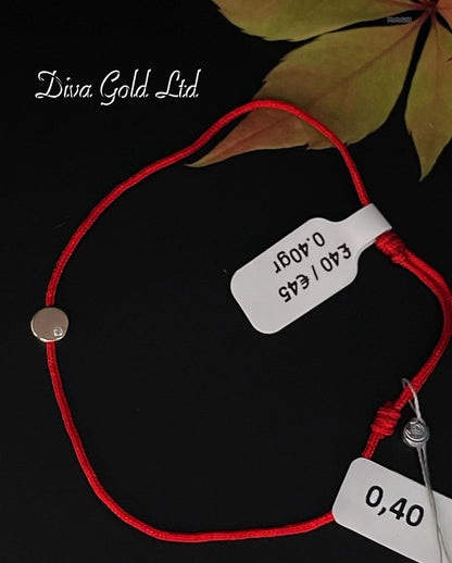 Red thread bracelet with gold details.