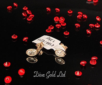 Stud gold earrings.