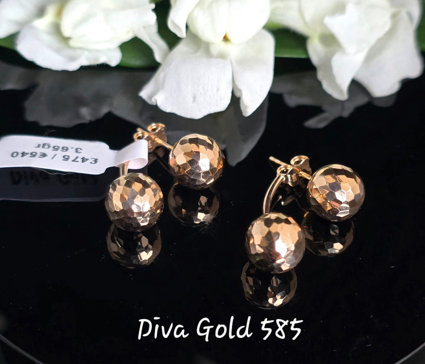 Stud gold earrings.
