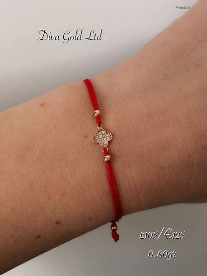 Red thread bracelet with 585 gold details. 0.80gram