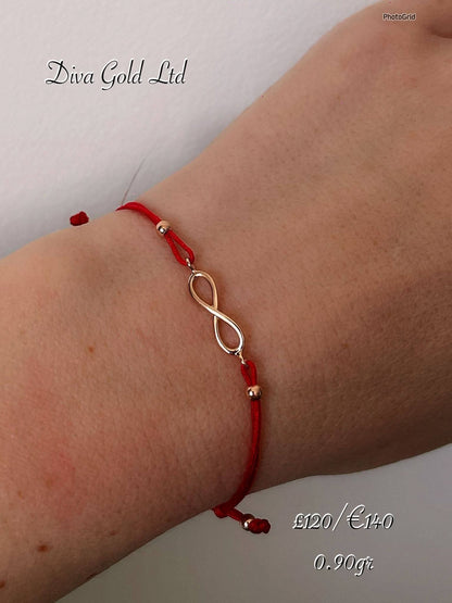 Red thread bracelet with 585 gold details. 0.90gram
