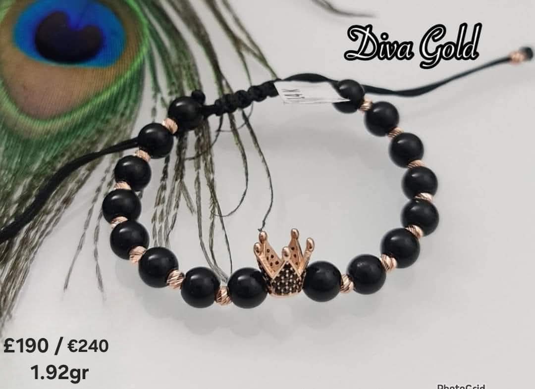 Black thread bracelet with gold details.