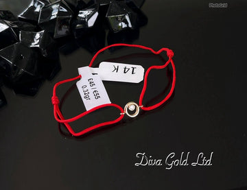 Red thread bracelet with 585 gold details.0.32gram