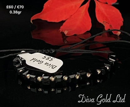 Black thread bracelet with 585 gold details. 0.38gram