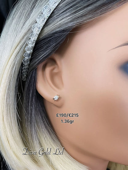 Stud gold earrings. White zircon stones