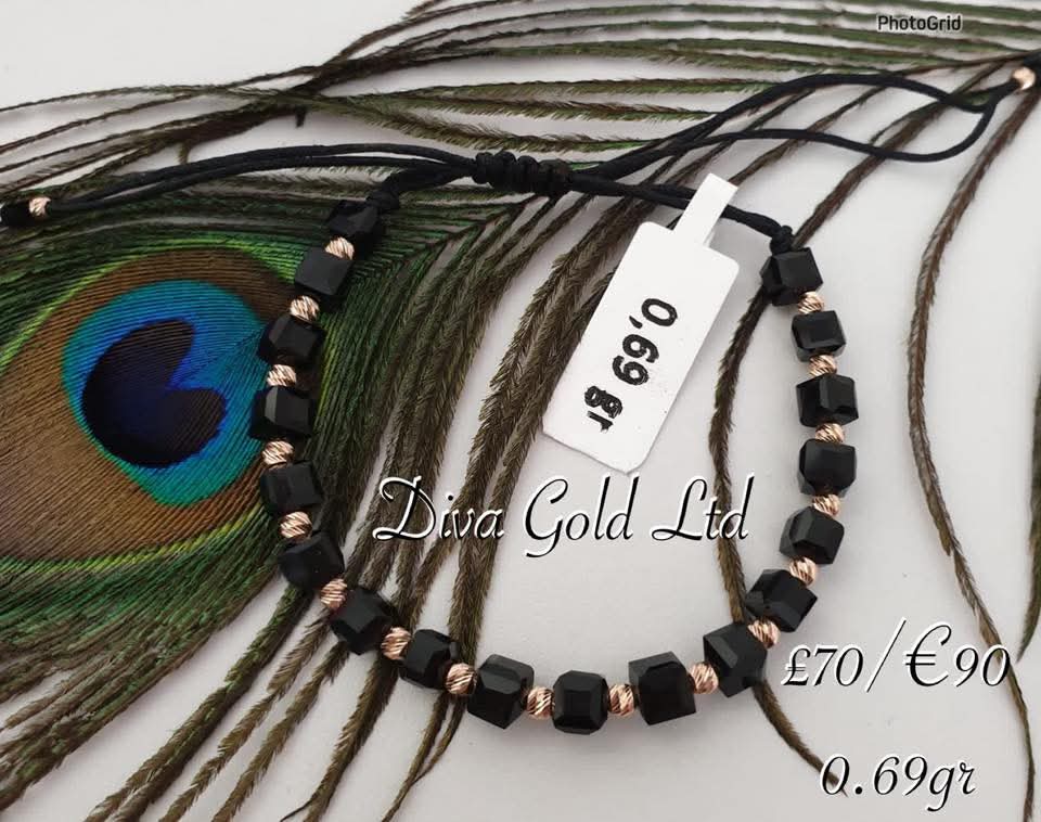 Black thread bracelet with gold details.