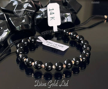 Black thread bracelet with 585 gold details. 0.68gram