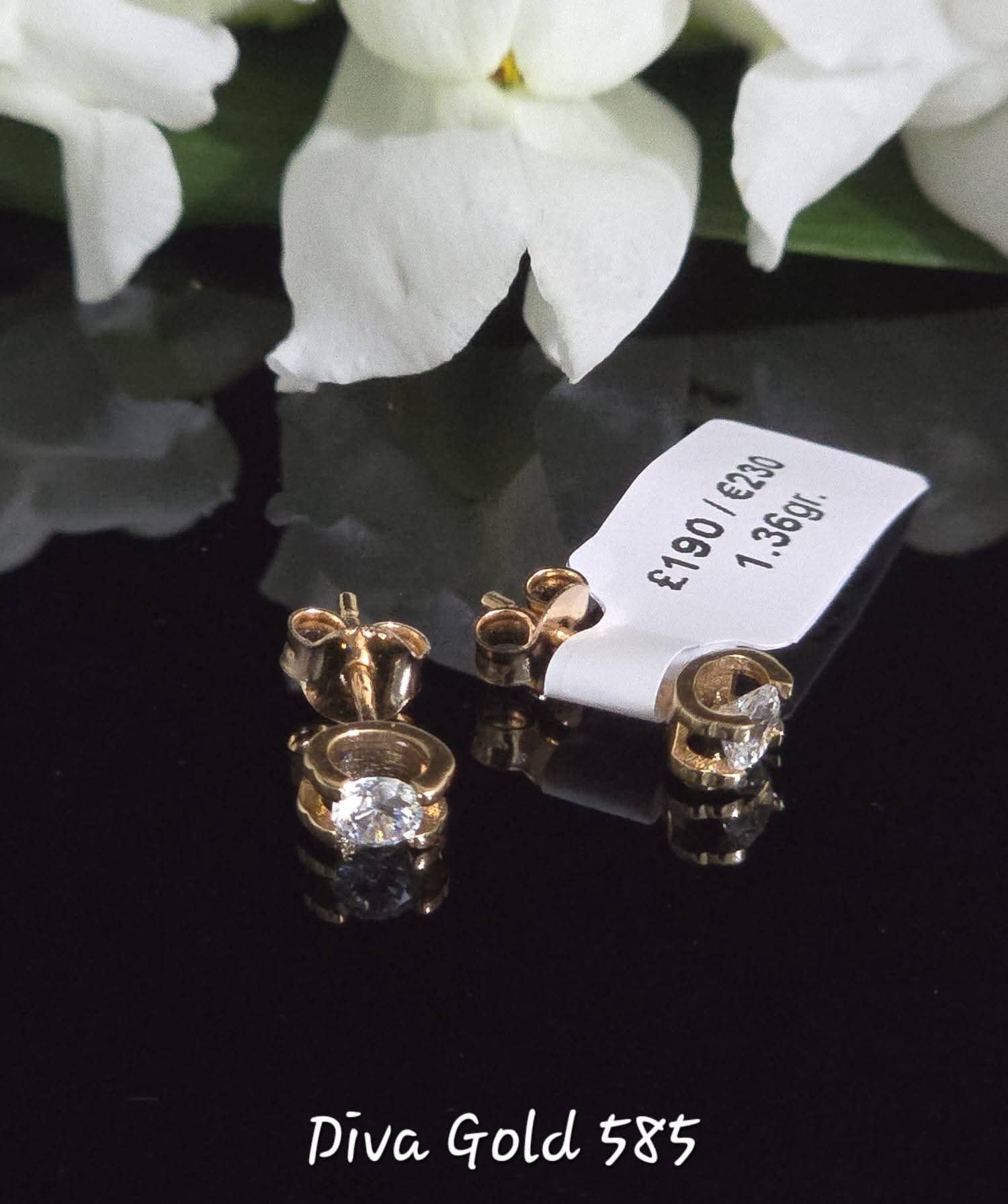 Stud gold earrings. White zircon stones