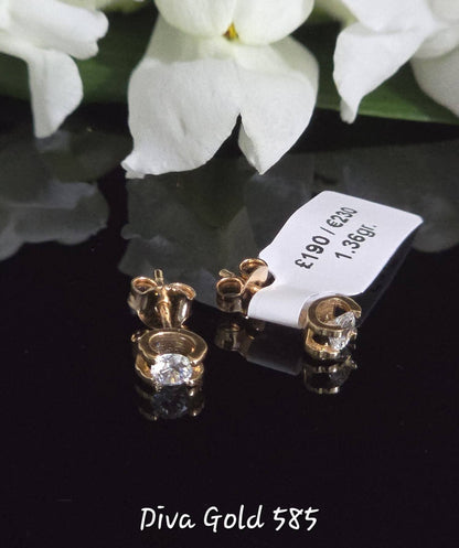 Stud gold earrings. White zircon stones
