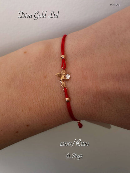 Red thread bracelet with 585 gold details. 0.74gram
